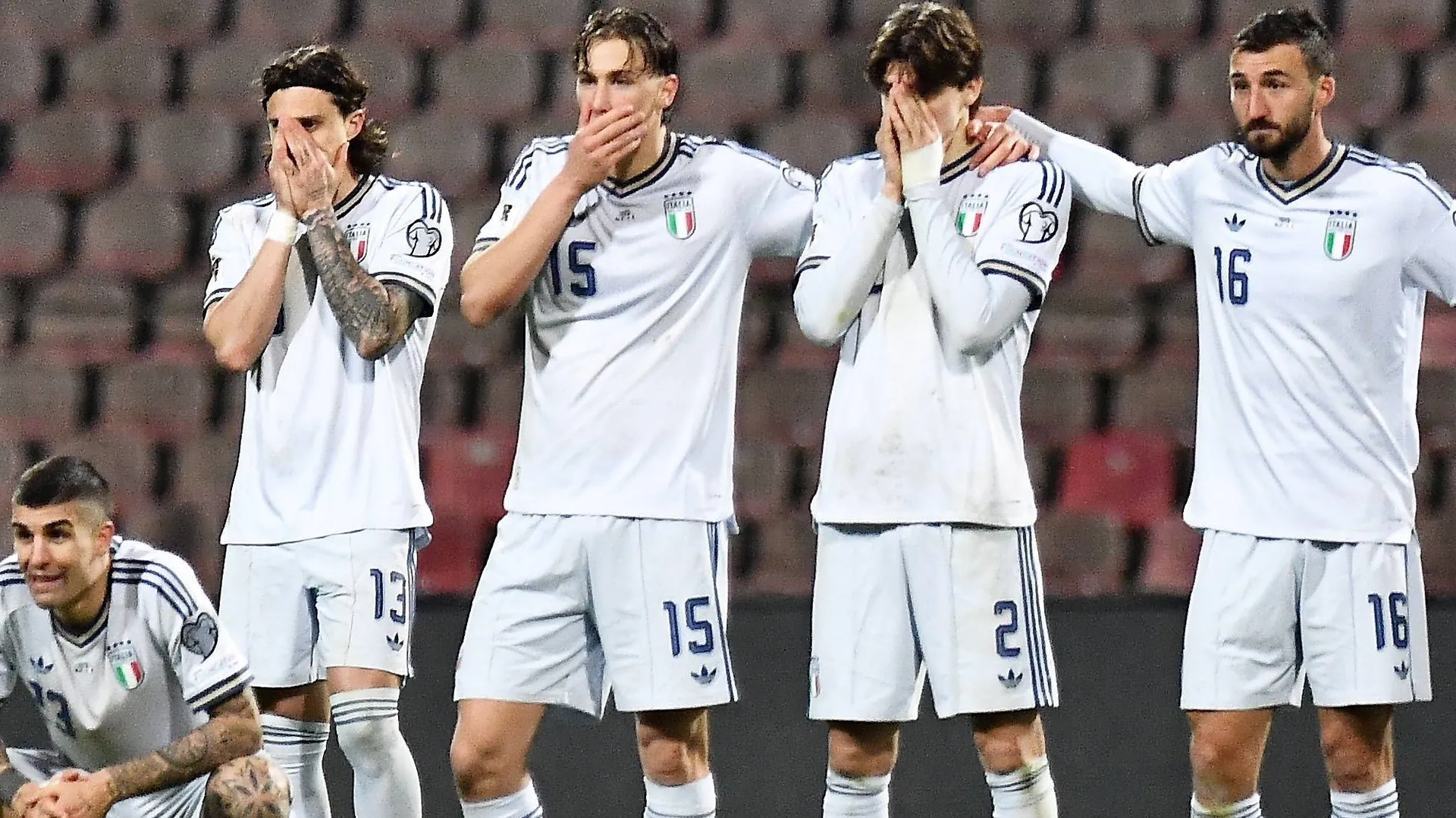 Shocked: Italy's national players watch the penalty shootout.