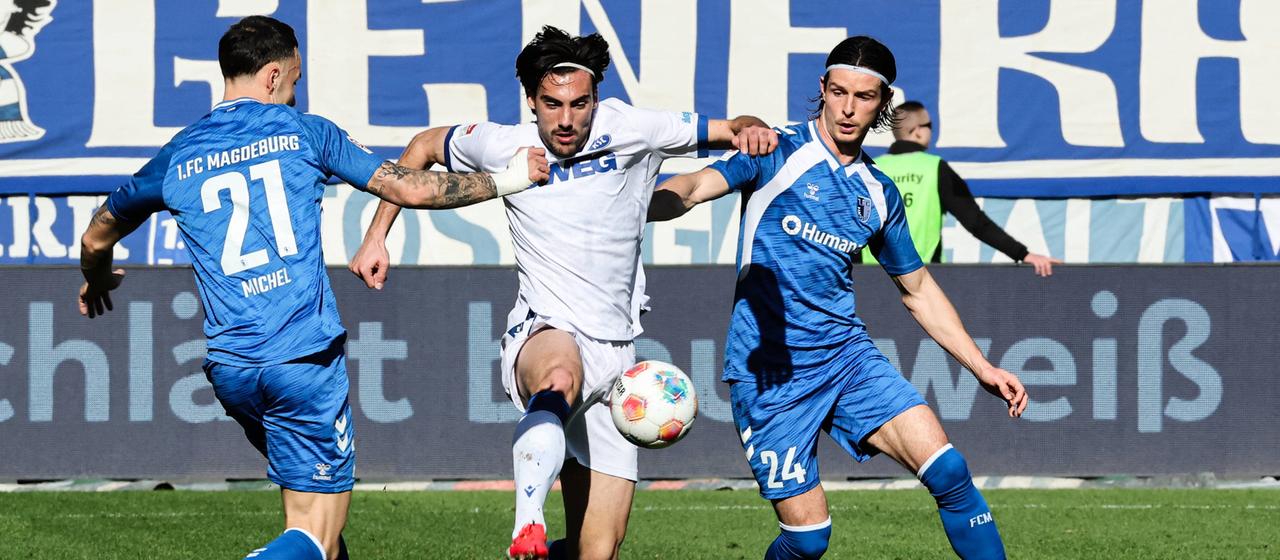 Magdeburg's Falko Michel in a duel with Karlsruhe's Roko Simic