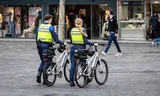 Enforcement officers walk through the center of Almere.