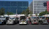 A driver checks his jeepney in Pasay city in the Philippines. Drivers see their costs increase due to the increase in gasoline prices. 
