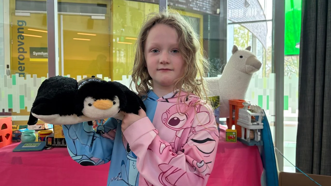 Roby-Anne with her new cuddly toy penguin