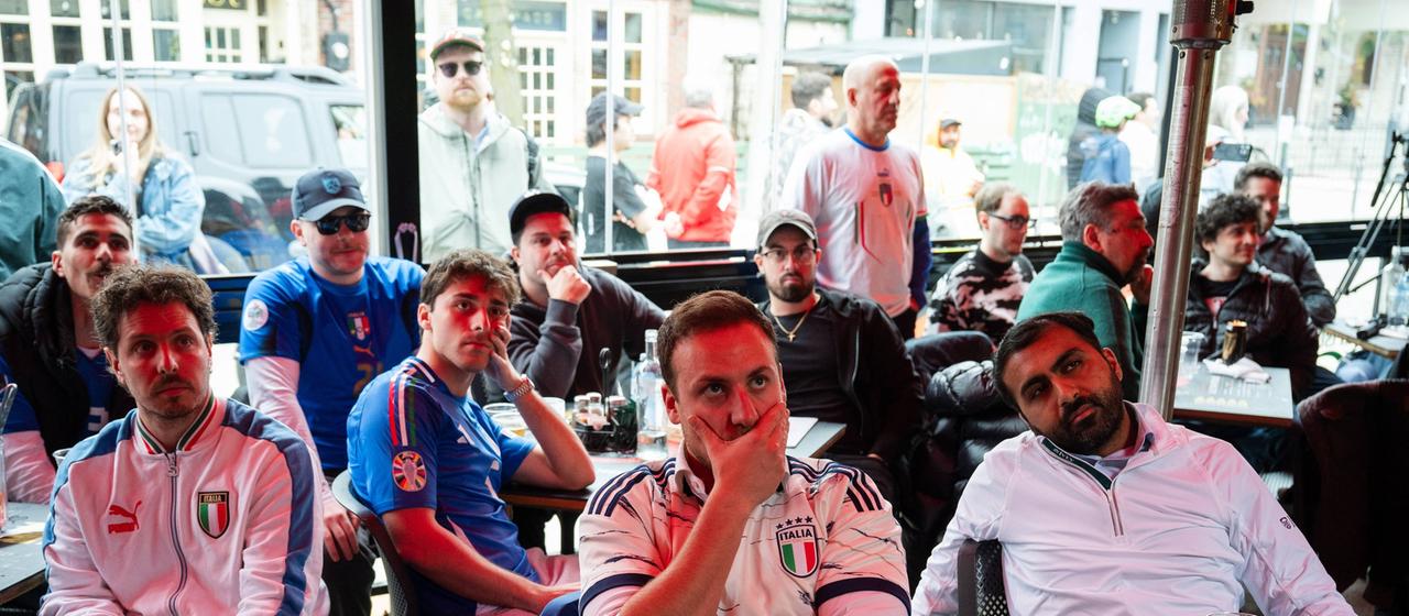 Fans of the Italian national team watch a game