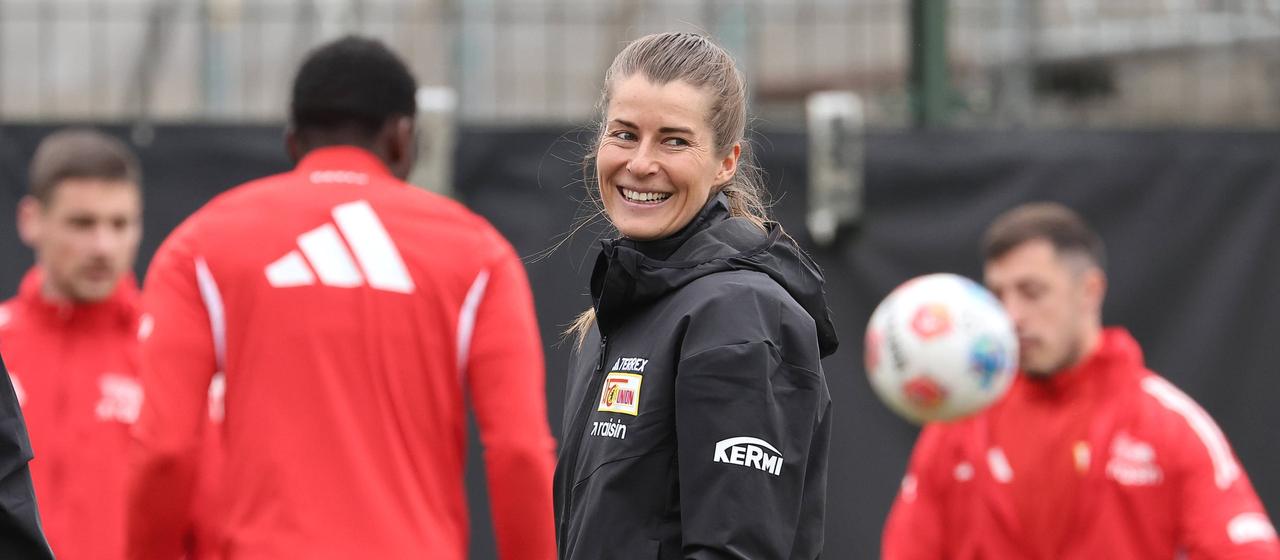 Soccer coach Marie-Louise Eta beams as she leads the first training session of Union Berlin's Bundesliga team.