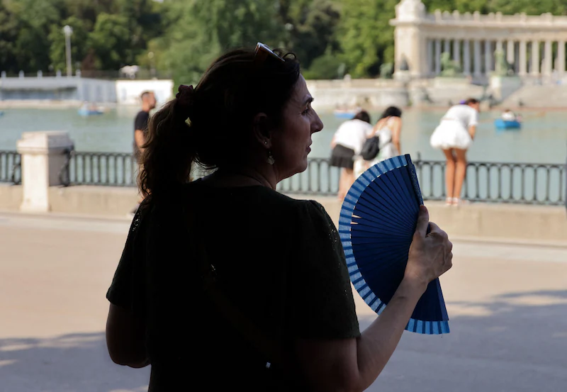 A woman wields a fan during a heat wave in Madrid last June.