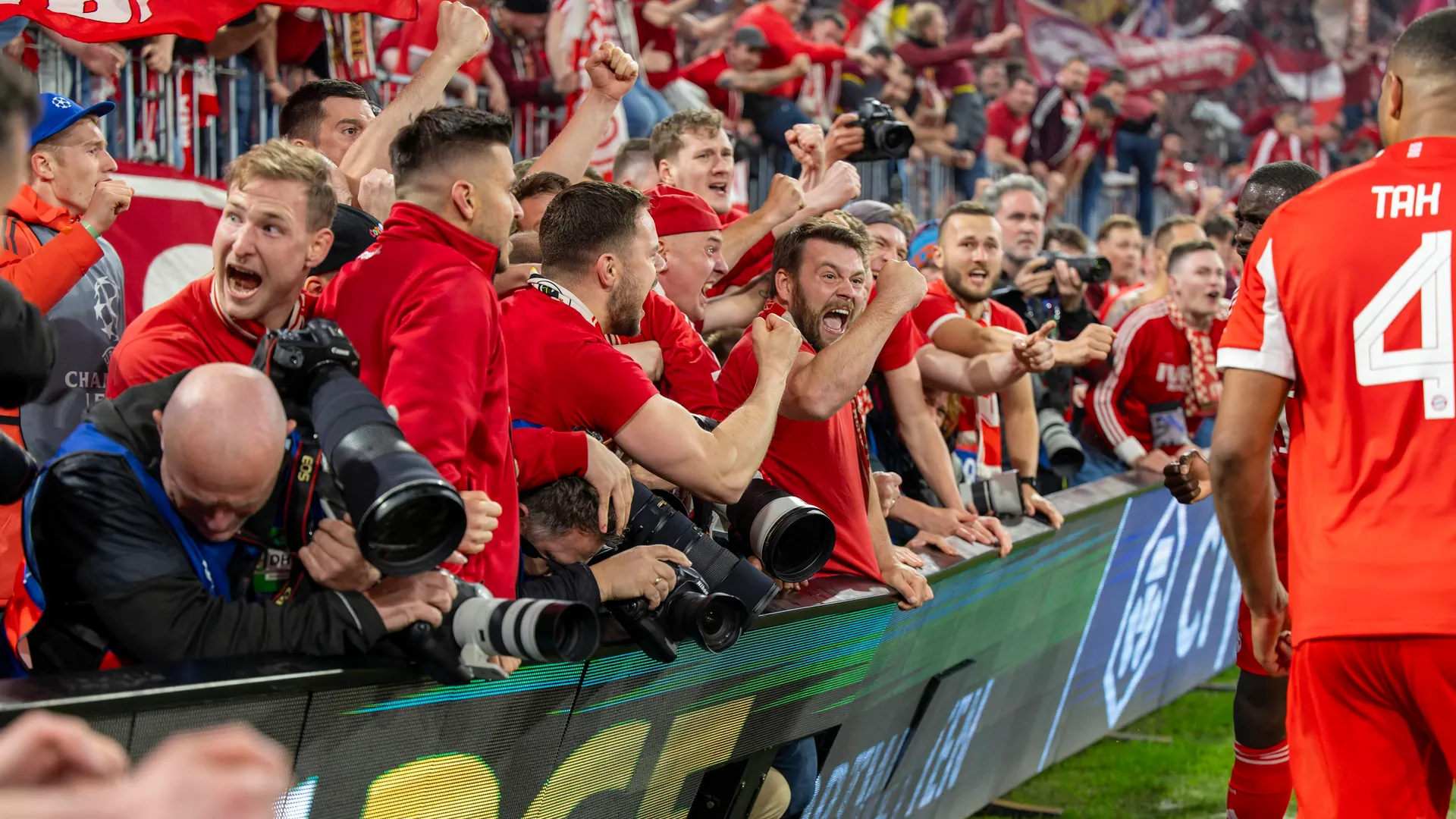 Lost control: Bayern fans cheer directly on the sidelines behind the advertising board. Lost control: Bayern fans cheer directly on the sidelines behind the advertising board.