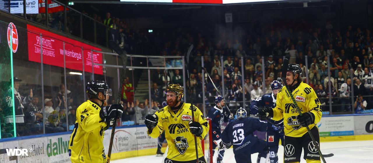 The Krefeld Pinguins players celebrate their goal against the Kassel Huskies