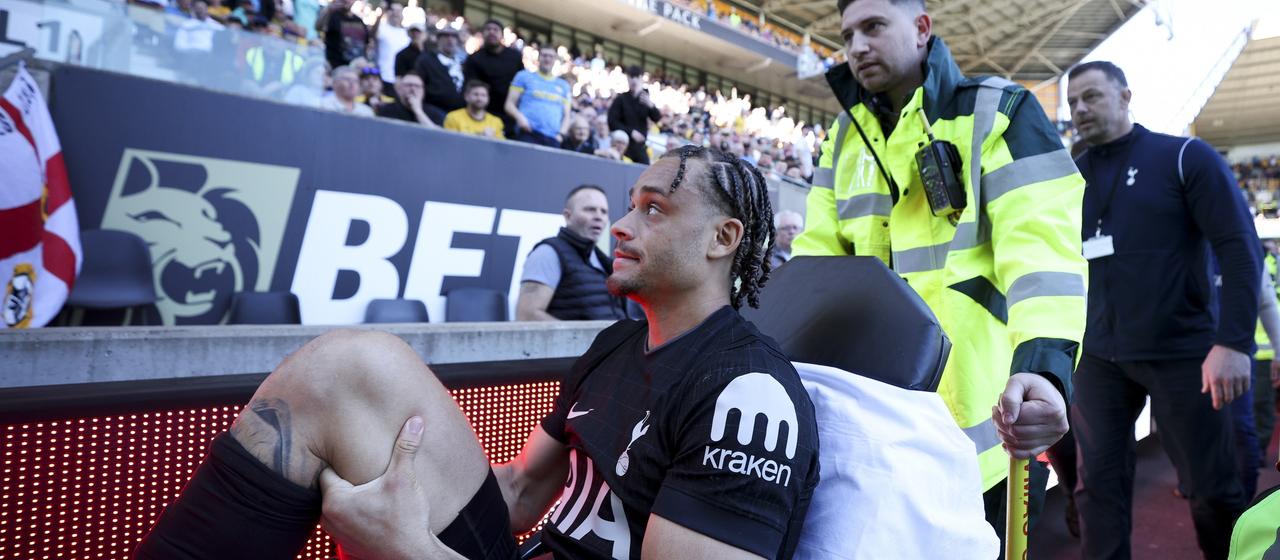 Tottenham striker Xavi Simons is carried off the pitch injured during the game in Wolverhampton 