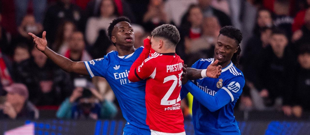 Benfica Lisbon's Gianluca Prestianni holds his jersey over his mouth in an argument with Real's Vinicius Jr