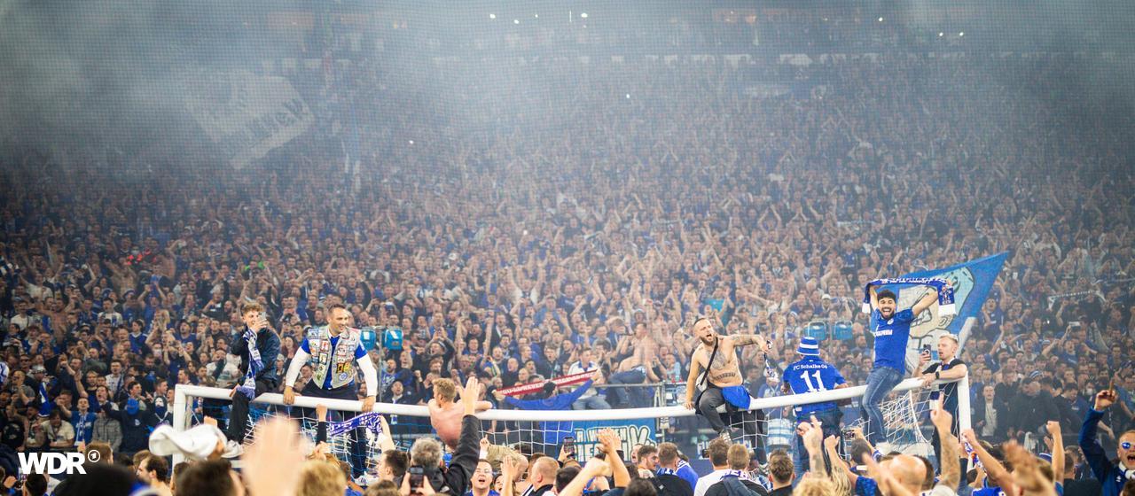Schalke fans celebrate indoors after the promotion game against St. Pauli
