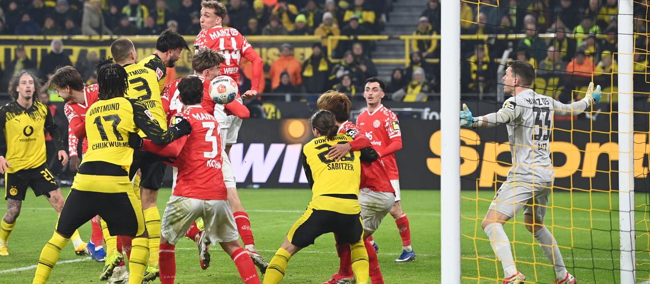 Mainz's Dominik Kohr (center) scores an own goal to make it 4-0 for Dortmund