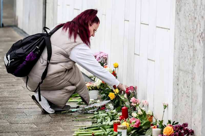 At the scene of the incident, people lay flowers for the victims.