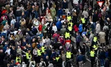 Demonstrators are escorted from Dam Square by the police prior to National Remembrance Day. 