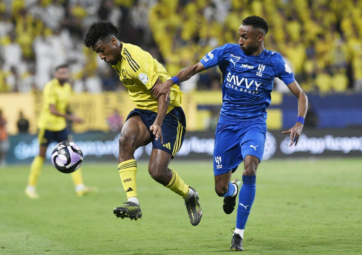 Kingsley Coman of Al Nassr and Mohamed Kanno of Al Hilal in action during the Al Nassr Saudi Professional League match against Al Hilal