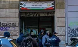 Police officers search an office of a charity association that supports Palestinians in Milan.