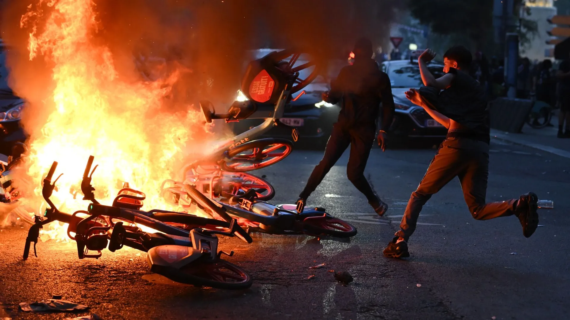 Lost control: rioters in Paris set bicycles on fire.