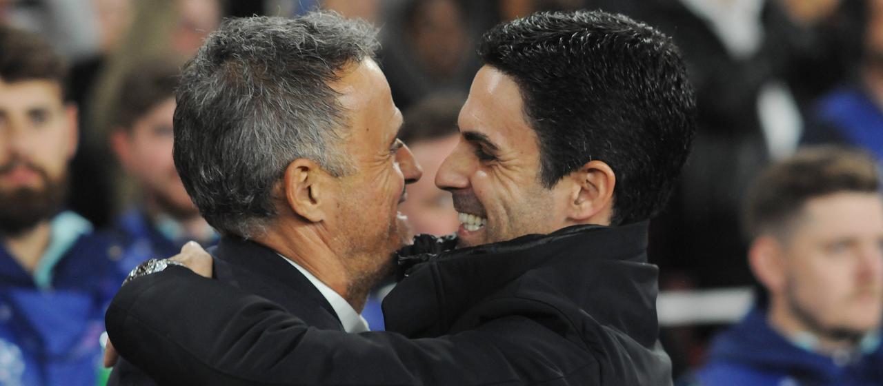   Luis Enrique (l.) and Mikel Arteta hug before the game between PSG and Arsenal in 2024