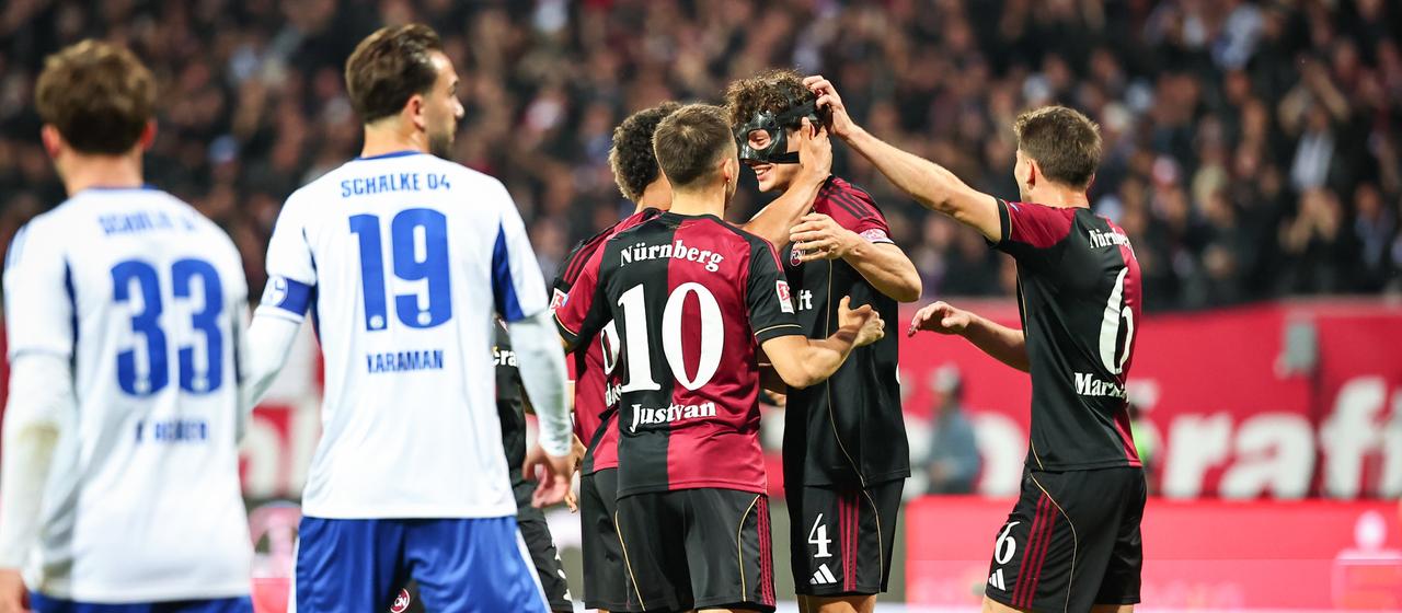 The Nuremberg team celebrate their opening goal in the game against Schalke 04