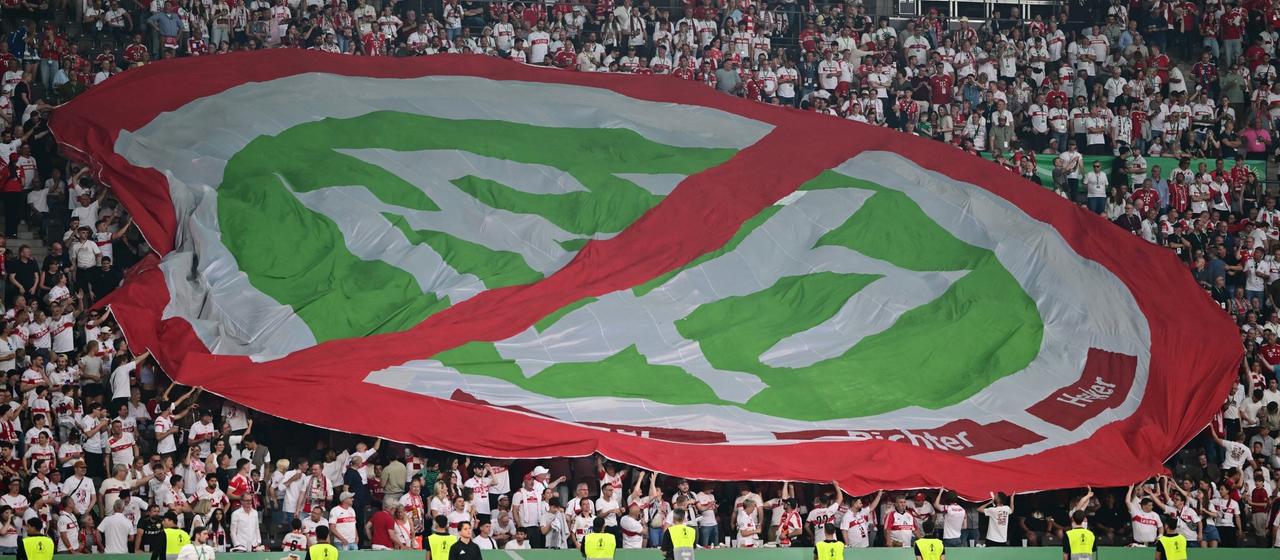 Football fans at the DFB Cup final hold a large protest banner against the DFB
