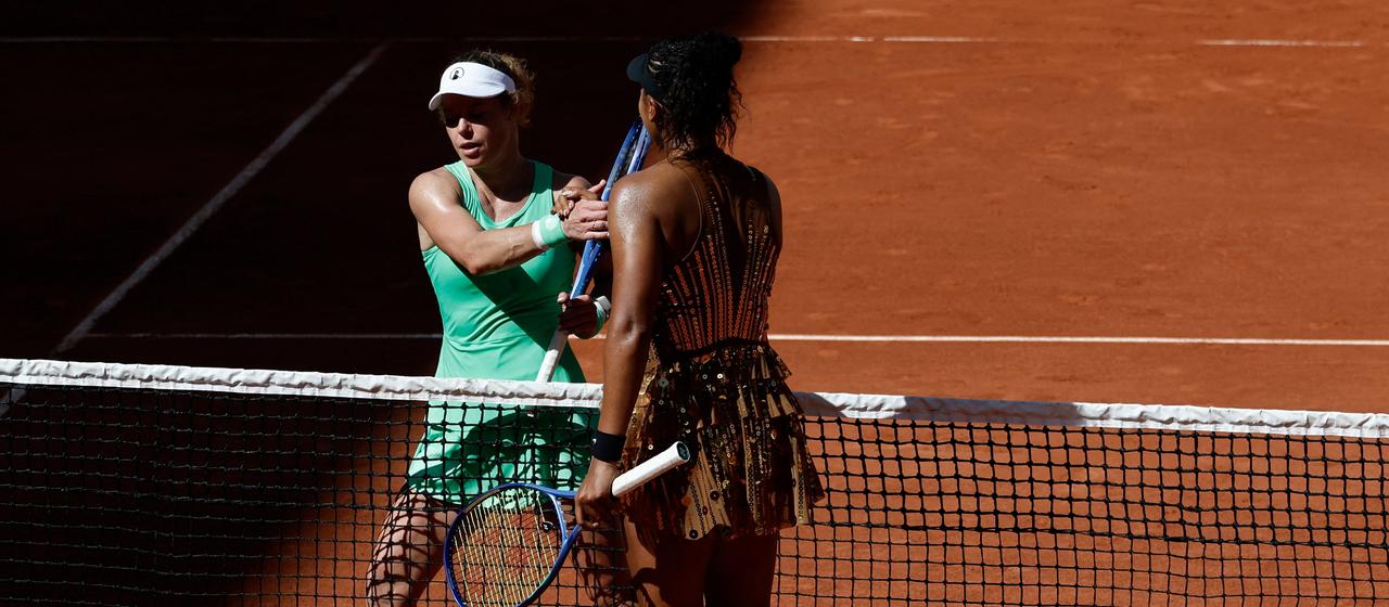 Laura Siegemund shakes Naomi Osaka's hand at the net