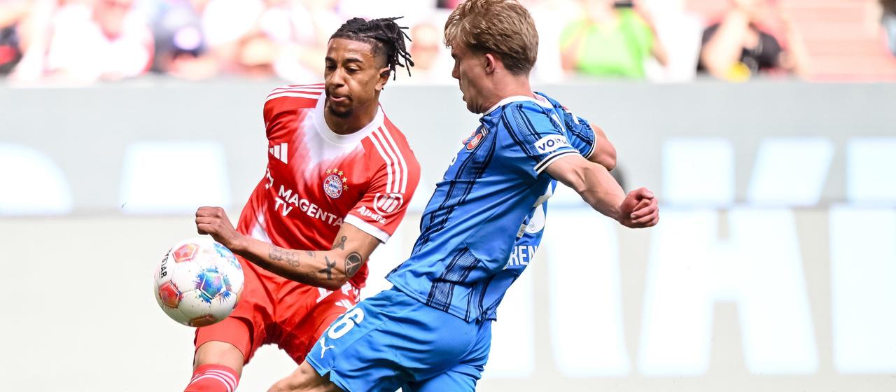 Bayern Munich's Michael Olise (l.) crosses in the Bundesliga game against 1. FC Heidenheim