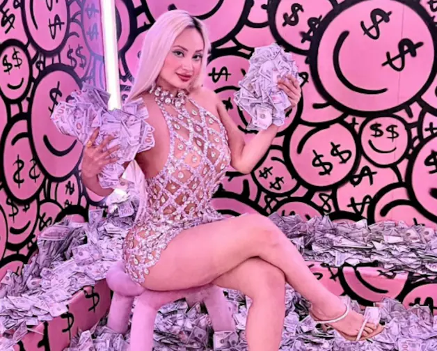 Nadeska Widausky poses with money bills.