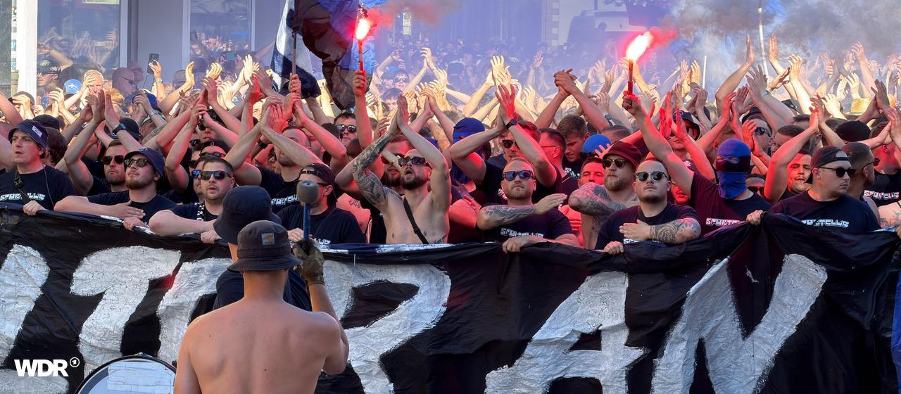 Hundreds of fans march through Parderborn with flags and beacons.