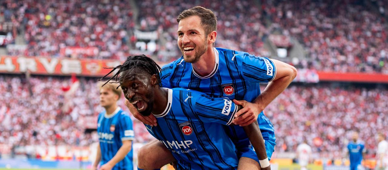 Heidenheim's Omar Traore (below) and Marvin Pieringer (above) celebrate a goal in Cologne