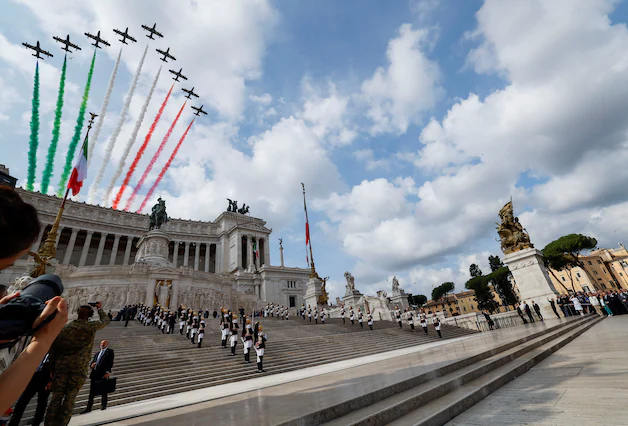 The Italian Air Force aerial acrobatics demonstration team, the Frecce Tricolori (Tricolor Arrows), flies over the “Altare della Patria” monument.