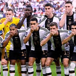 Players of the German national team hold their hands over their mouths