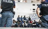 Police keep guard as around 400 Migrants wait to be put on a night ferry to Sicily, from where they want to be dispersed to other centers and refuges around Italy. September 2025