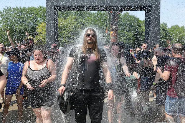 Visitors are cooled down at the Hellfest festival.