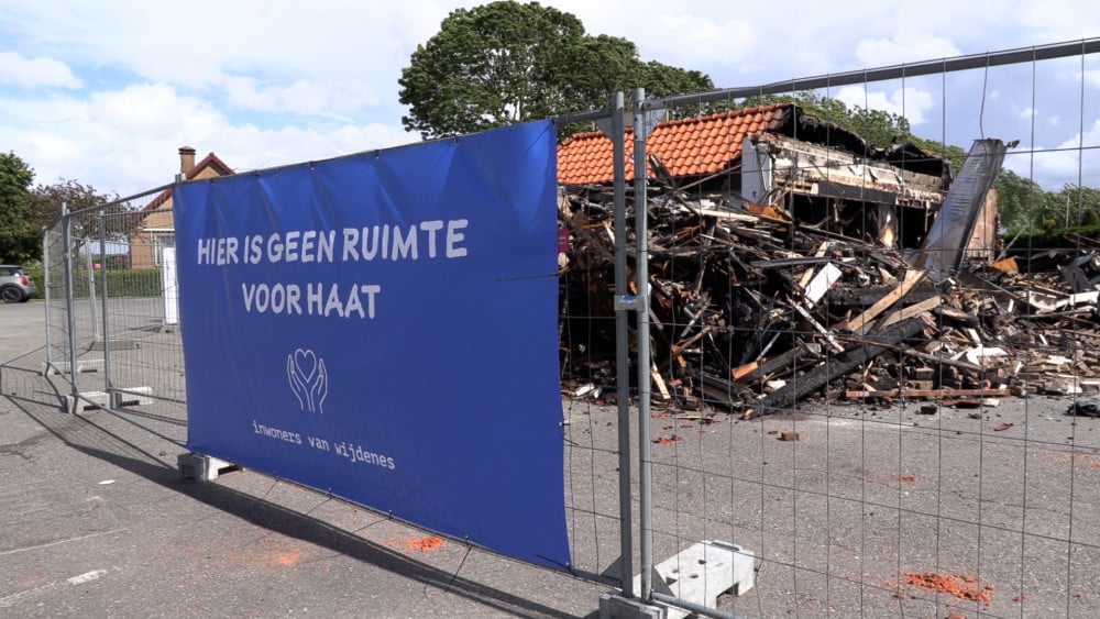 Banners against hate hung at a burned down restaurant in Wijdenes
