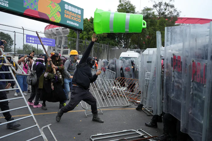 Chaos breaks out outside the World Cup stadium in Mexico: footage shows demonstrators throwing items at police | Sport