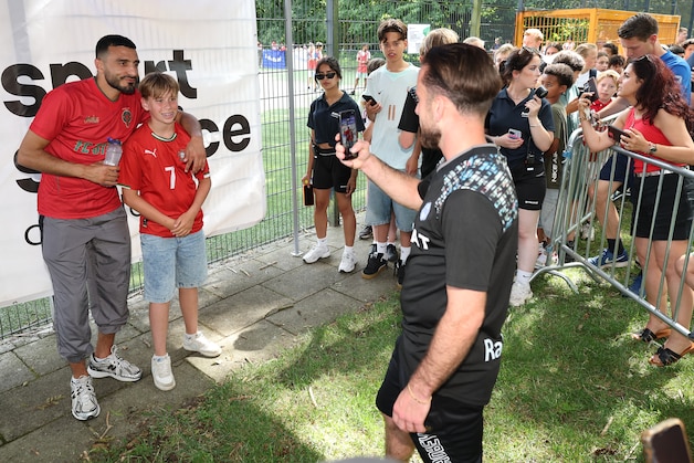 Children line up for a photo with Soufiane Touzani.