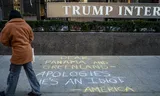 Anti-Trump graffiti in front of the Trump International Hotel in New York that reads 'Dear Panama and Groeland – our apologies, he's an idiot. – America'