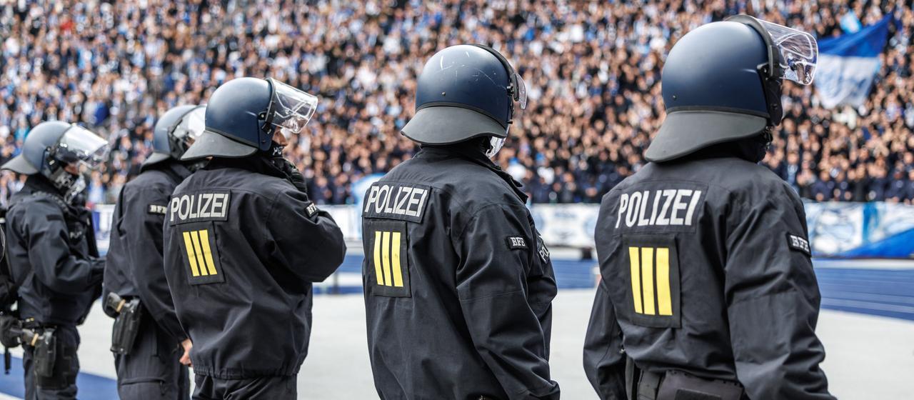 Police officers in front of a fan curve 