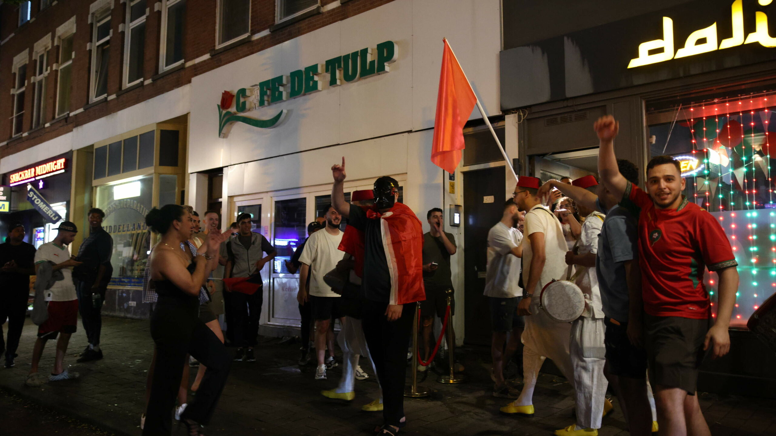 Fireworks, flags and honking cars: large groups of fans took to the streets in The Hague and Rotterdam after Morocco’s win