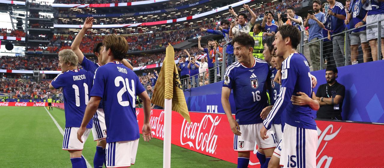 The Japanese players celebrate their goal against the Netherlands
