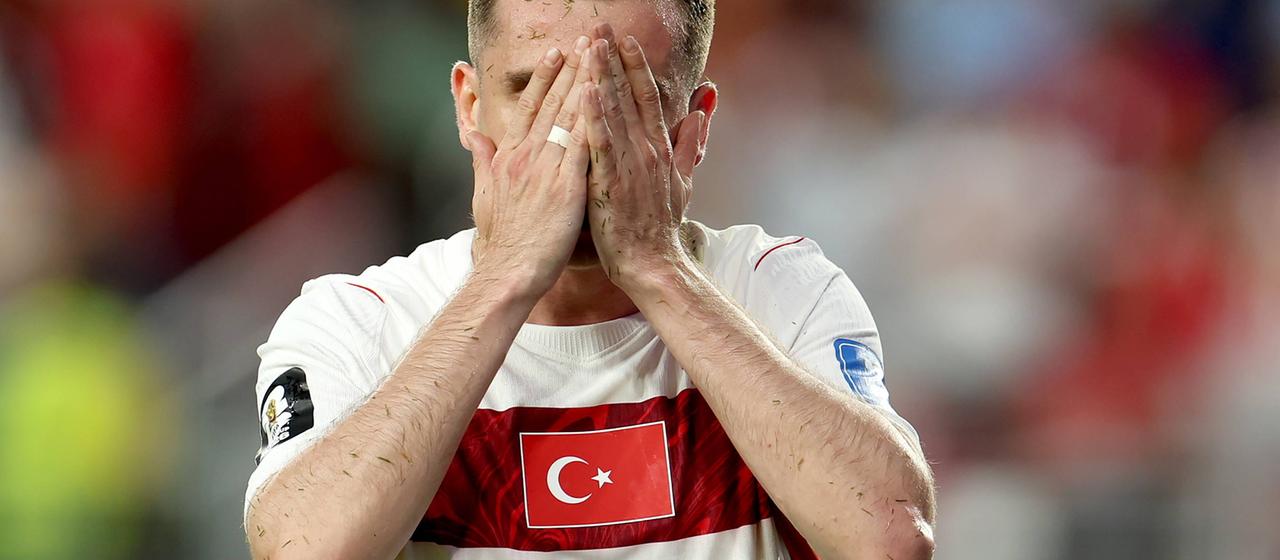 Kerem Akturkoglu of Turkey covers his face with his hands.