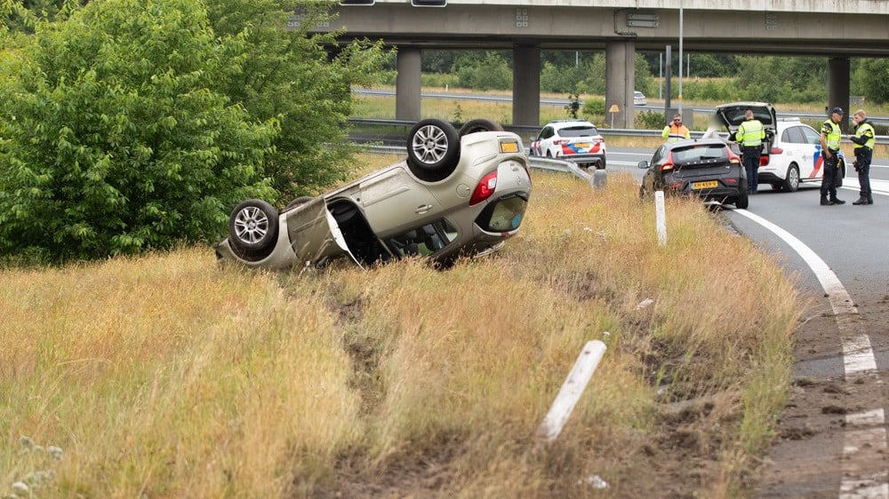 Red Cross passers-by come to the aid of a woman in a crash on the A1