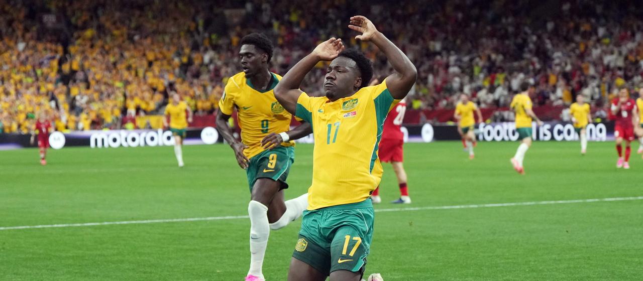 The Australian Nestory Irankunda (r) celebrates after his goal to make it 1-0 with Mohamed Touré.
