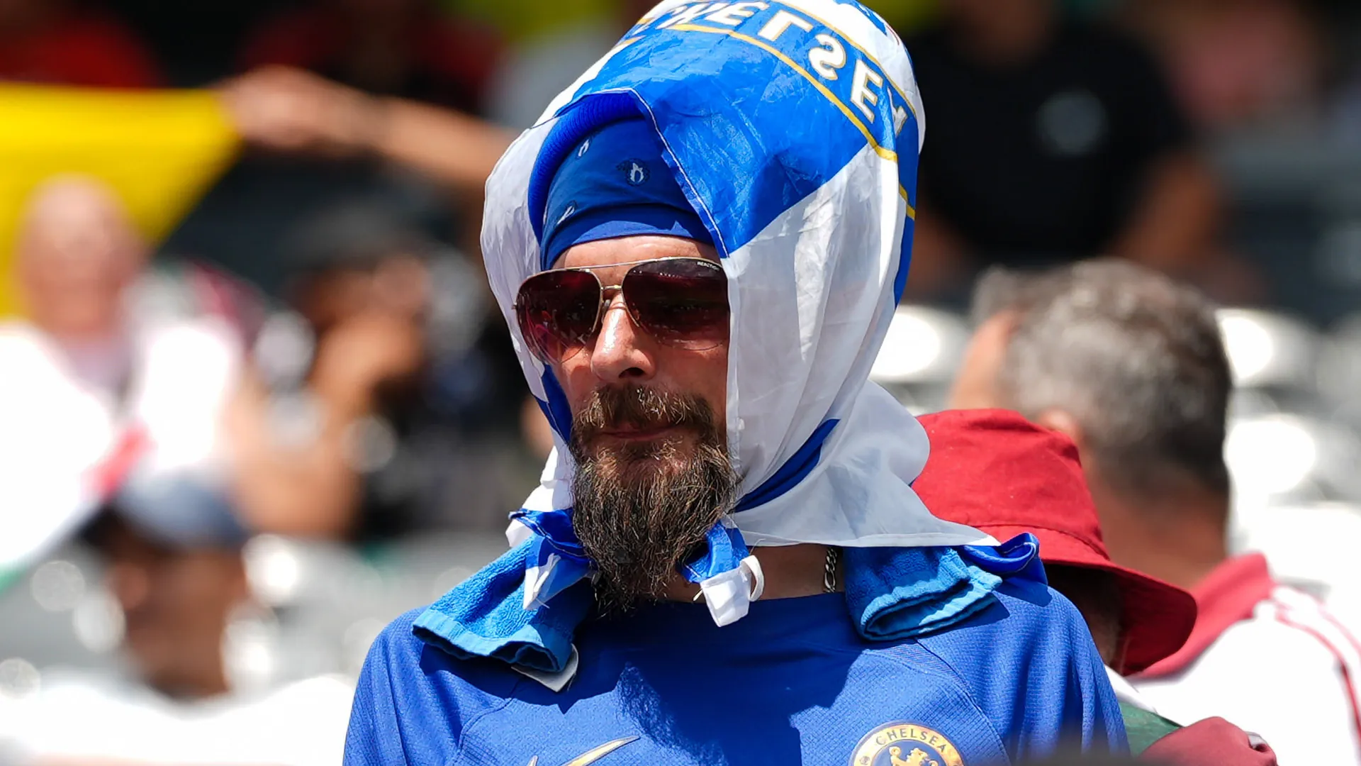A Chelsea fan tries to protect himself from the heat at the 2025 Club World Cup.