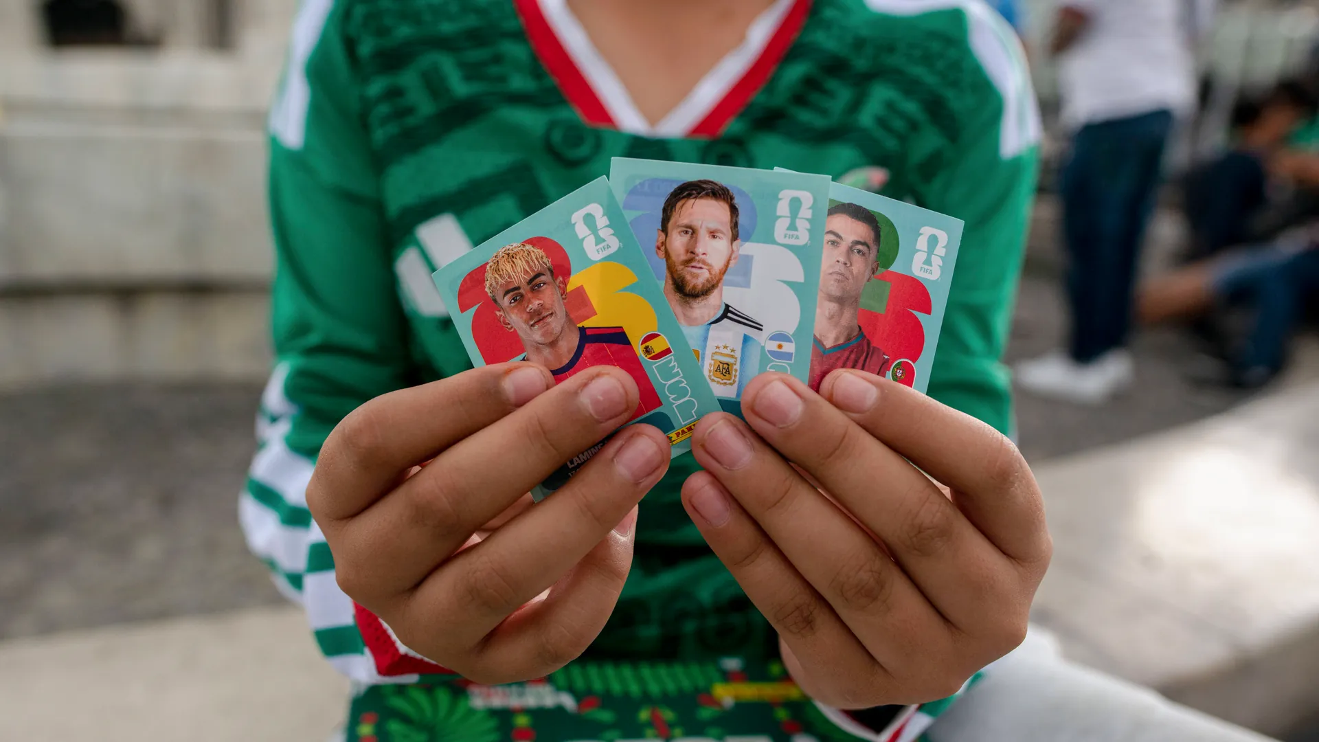 A Mexican fan shows his stickers: Thousands of Panini pictures change hands at swap meets, like the one here in the Plaza de Bellas Artes in Mexico City.