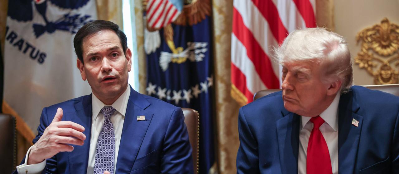 Marco Rubio and Donald Trump sit next to each other.