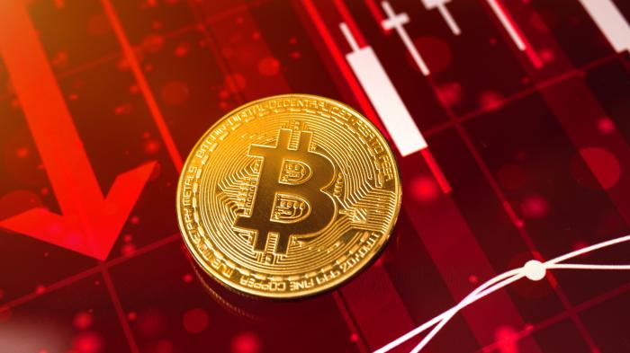 Bitcoin coin with downward arrows
